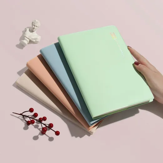 Stacked pastel notebooks on a table